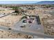 Areal view of property with a backyard pool, a garage, landscaping, and a storage building at 1361 Moose St, Pahrump, NV 89048