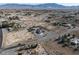 Areal view of a property, including a pool, a garage, outbuildings, and nice landscaping at 1361 Moose St, Pahrump, NV 89048