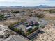Aerial view of an estate featuring a pool, garage, landscaping, and other outbuildings at 1361 Moose St, Pahrump, NV 89048