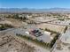Areal view of a single-Gathering house with a pool, landscaping, a garage, and outbuildings at 1361 Moose St, Pahrump, NV 89048