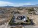 Areal shot of a landscaped property with a pool, a garage, and other outbuildings at 1361 Moose St, Pahrump, NV 89048