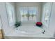 Relaxing bathroom featuring a large soaking tub, plantation shutters, and bright natural light at 1361 Moose St, Pahrump, NV 89048
