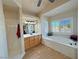 Bright bathroom with a soaking tub, separate shower, and a large vanity mirror at 1361 Moose St, Pahrump, NV 89048