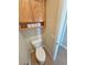 Cozy powder room featuring a toilet, in-wall storage, and tiled flooring at 1361 Moose St, Pahrump, NV 89048