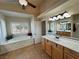 Bright bathroom with a soaking tub, and vanity at 1361 Moose St, Pahrump, NV 89048