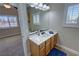 Bathroom with neutral tones, single sink vanity, and view to bedroom at 1361 Moose St, Pahrump, NV 89048