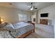 Well-lit bedroom with a vaulted ceiling, a TV, and neutral carpet flooring at 1361 Moose St, Pahrump, NV 89048