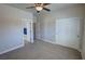 View of bedroom with carpet, white-painted trim and ensuite bathroom with towels at 1361 Moose St, Pahrump, NV 89048