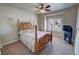 This primary bedroom features a ceiling fan, carpet and large window with shutters at 1361 Moose St, Pahrump, NV 89048
