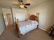 This primary bedroom features a ceiling fan, carpet and large window with shutters at 1361 Moose St, Pahrump, NV 89048