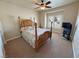 This primary bedroom features a ceiling fan, carpet and large window with shutters at 1361 Moose St, Pahrump, NV 89048