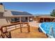 View of the deck steps to the back yard which has an above ground pool and covered patio at 1361 Moose St, Pahrump, NV 89048