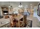 Spacious dining area with wood table, open to kitchen and living room, with tile flooring throughout at 1361 Moose St, Pahrump, NV 89048