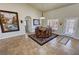 Bright dining area with high ceilings, tile floors, decorative artwork, and direct outdoor access at 1361 Moose St, Pahrump, NV 89048