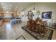 Open-concept dining room with a vaulted ceiling, tile flooring, and a wooden dining set at 1361 Moose St, Pahrump, NV 89048
