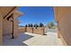 Covered porch area with stucco pillars and low walls, desert landscaping and a gravel yard at 1361 Moose St, Pahrump, NV 89048
