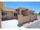 Covered patio seating area with neutral-colored chairs, stucco columns, and well-maintained landscaping at 1361 Moose St, Pahrump, NV 89048