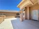 Covered outdoor area with seating space, stucco columns, and an access door to the home at 1361 Moose St, Pahrump, NV 89048