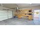 Functional garage space featuring built-in workbench, cabinetry, and exterior access at 1361 Moose St, Pahrump, NV 89048