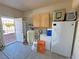 Garage interior with large water tank, storage cabinets, freezer, and outside access at 1361 Moose St, Pahrump, NV 89048