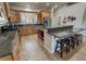 Spacious kitchen with stainless appliances, wood cabinets, granite counters and extended island seating at 1361 Moose St, Pahrump, NV 89048