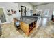 Kitchen island with granite counters, light wood cabinets, storage and dining space, plus a built-in trash receptacle at 1361 Moose St, Pahrump, NV 89048