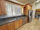 Kitchen featuring wood cabinets, stainless appliances, granite counters, and a walk-in pantry at 1361 Moose St, Pahrump, NV 89048