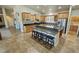 Bright kitchen featuring a central island with bar seating, wooden cabinets, and granite counters at 1361 Moose St, Pahrump, NV 89048