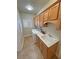 Spacious laundry room featuring sink, cabinetry and a modern washer/dryer set at 1361 Moose St, Pahrump, NV 89048