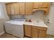 Spacious laundry room featuring sink, cabinetry and a modern washer/dryer set at 1361 Moose St, Pahrump, NV 89048