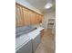 Spacious laundry room featuring sink, cabinetry and a modern washer/dryer set at 1361 Moose St, Pahrump, NV 89048