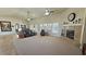Spacious carpeted living room features a fireplace, windows with shutters, and comfortable seating at 1361 Moose St, Pahrump, NV 89048