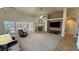 Open living room featuring a fireplace, large windows with shutters, and neutral tones at 1361 Moose St, Pahrump, NV 89048