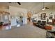 A large living room with tile flooring, furnishings, and an open view to the dining room at 1361 Moose St, Pahrump, NV 89048