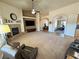 Large carpeted living room showcases fireplace, media niche, and easy access to other rooms at 1361 Moose St, Pahrump, NV 89048