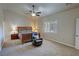 Comfortable bedroom features a ceiling fan, a cozy chair, and plenty of natural light at 1361 Moose St, Pahrump, NV 89048