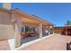 Exterior view of the backyard covered patio, barbecue area, and access to the above ground pool at 1361 Moose St, Pahrump, NV 89048