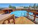 This wood deck leads to an above ground pool and views of the barbecue area and back yard at 1361 Moose St, Pahrump, NV 89048