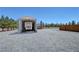 View of the RV parking on the property, with metal awning and gravel surround at 1361 Moose St, Pahrump, NV 89048