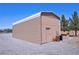 Large metal shed with a side door and small shed for storing tools at 1361 Moose St, Pahrump, NV 89048