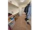 Neat walk-in closet featuring shelving, hanging rods, and carpet flooring at 1361 Moose St, Pahrump, NV 89048