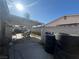 Outdoor covered patio with concrete flooring, surrounded by a cinder block wall, and cluttered with tires and furniture at 1429 S Sandhill Rd, Las Vegas, NV 89104