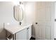 Bathroom includes vanity with sink, quartz countertop, modern black fixtures, and white cabinetry at 1601 Iguana St, Pahrump, NV 89048