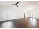 Bright and open living room with high ceilings, neutral paint, ceiling fan and wood-look flooring at 1601 Iguana St, Pahrump, NV 89048
