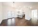 Open-concept living room with bright neutral color, and view of a modern kitchen, and backyard access at 1601 Iguana St, Pahrump, NV 89048