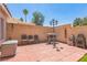 Enclosed backyard featuring a barbecue grill, brick pavers, and desert landscaping at 169 Alterra Dr, Henderson, NV 89074