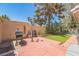 Enclosed backyard featuring a barbecue grill, brick pavers, and artificial grass at 169 Alterra Dr, Henderson, NV 89074
