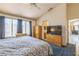 Bedroom with ensuite bathroom, TV, and large windows at 169 Alterra Dr, Henderson, NV 89074