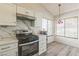 Bright kitchen featuring white cabinets, stainless steel appliances, and laminate flooring at 169 Alterra Dr, Henderson, NV 89074