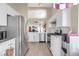 Kitchen area with stainless steel appliances, white cabinets, and an open floor plan at 169 Alterra Dr, Henderson, NV 89074